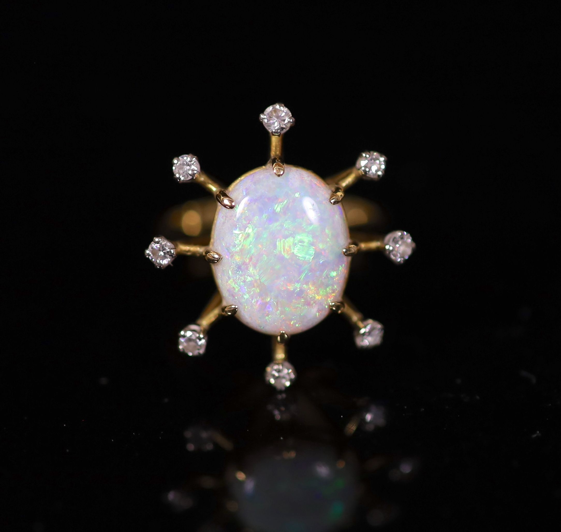 An 18ct gold, single stone oval white opal and eight stone diamond set modernist ring